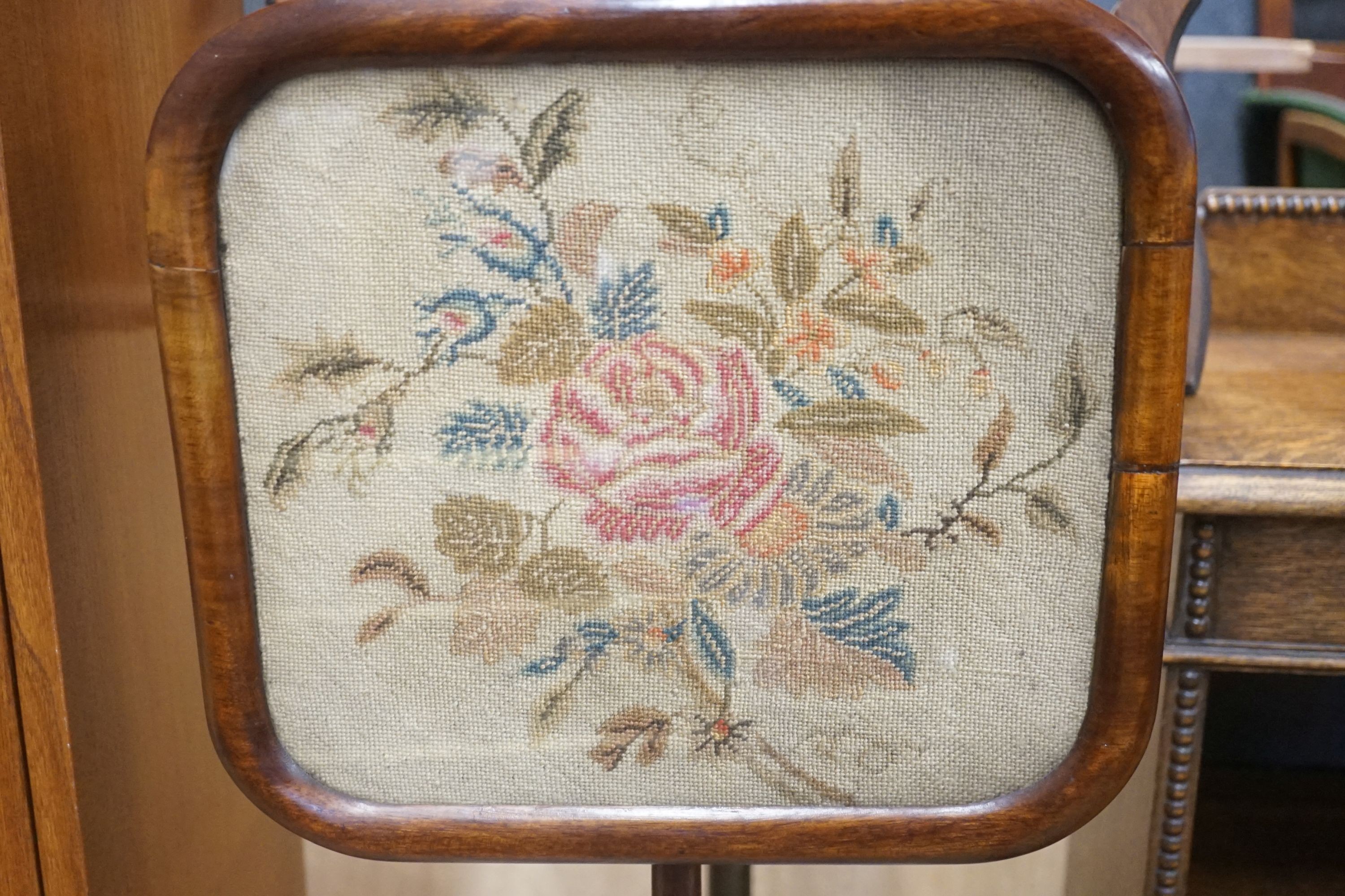 A Victorian rosewood pole screen and a fret cut music stand